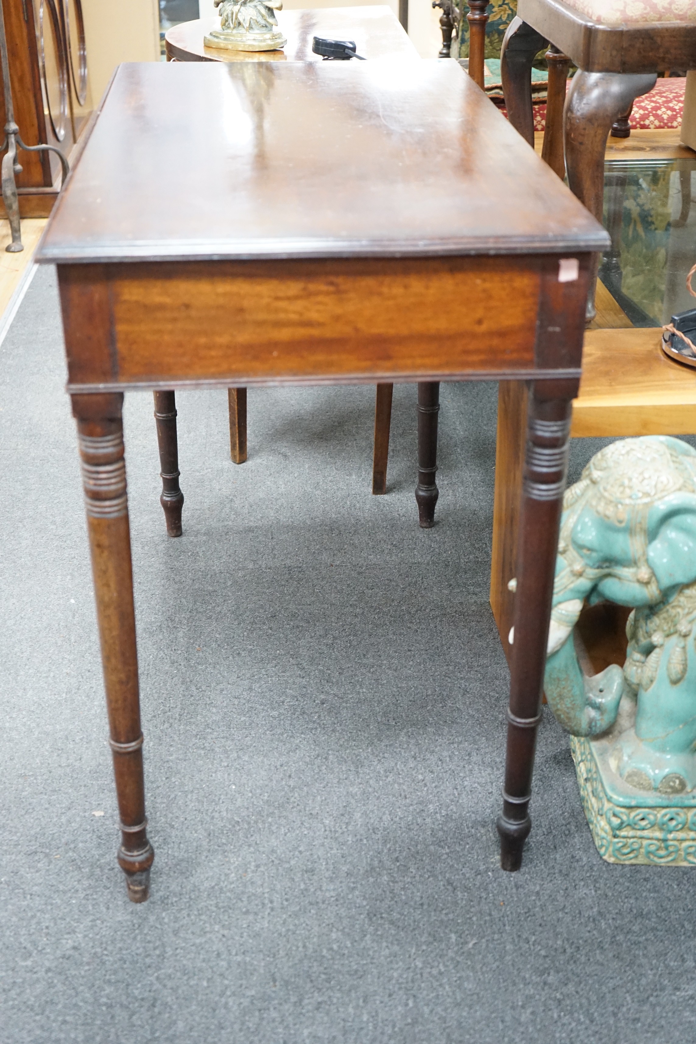 A Regency mahogany two drawer side table with moulded edge on turned legs, width 95cm, depth 51cm, height 78cm